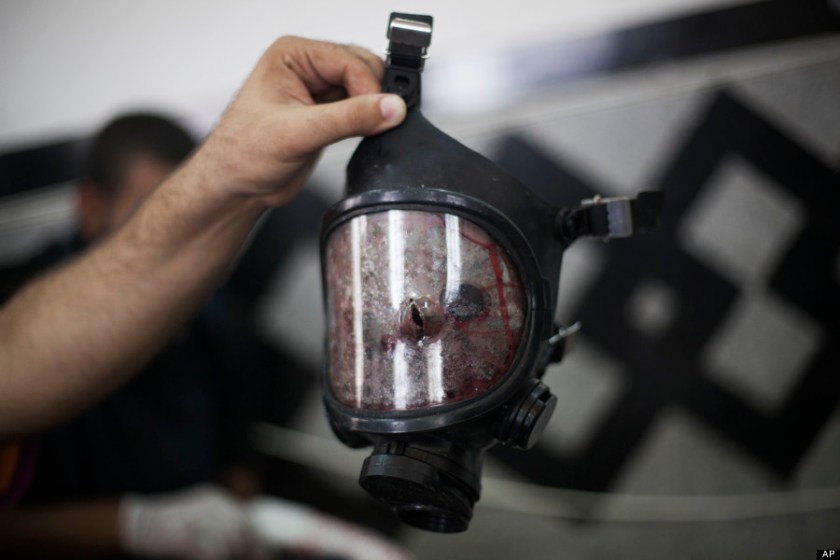 A bullet hole is seen in the front of a gas mask belonging to a supporter of ousted Egyptian President Mohammed Morsi in Cairo's Nasr City district, Egypt, Wednesday, Aug. 14, 2013. Egyptian police in riot gear swept in with armored vehicles and bulldozers Wednesday to clear two sprawling encampments of supporters of the country's ousted Islamist president in Cairo, showering protesters with tear gas as the sound of gunfire rang out. (AP Photo/Manu Brabo)