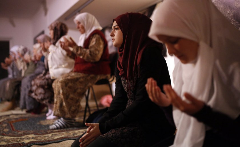 Bosnian Muslims offer a prayer during late night prayer for upcoming holy month of Ramadan, inside memorial room for Srebrenica massacre victims, at the memorial center Potocari, northeast of the Bosnian capital of Sarajevo. Family members of the Srebrenica victims killed in July, 1995, will mark the first night of Ramadan at the memorial center Potocari, in front of the graves of killed Muslims from this small Bosnian town. Amel Emric / AP 