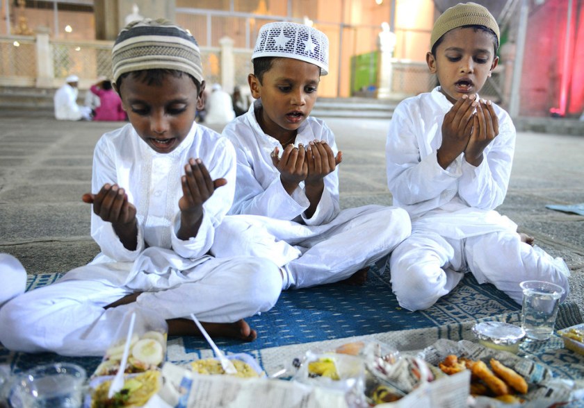 Indian Muslim boys offer prayers prior to breaking their fast on the first day of the Islamic holy month of Ramadan at Mecca Masjid in Hyderabad.  Noah Seelam / AFP / Getty Images 