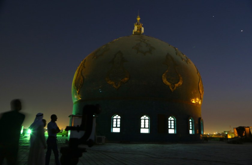 Iraqi Muslim men gather, on the roof of Imam Ali Mosque, waiting to see the crescent moon marking the beginning of Ramadan, at sunset in Basra, Iraq. Nabil Al-jurani / AP 